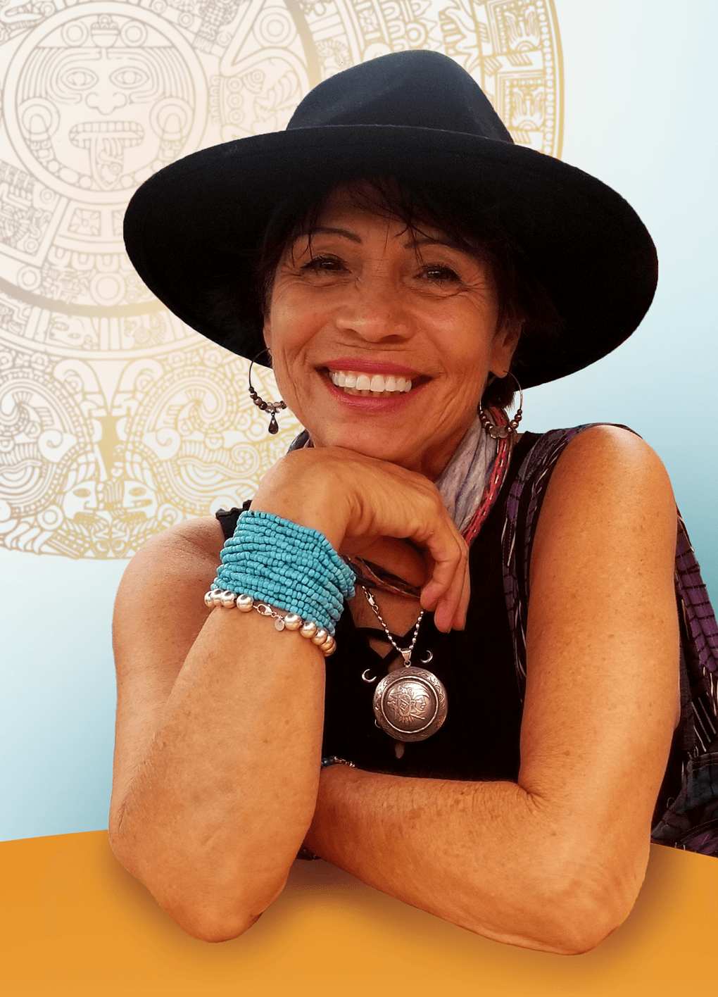 Smiling woman wearing a wide-brimmed hat, colorful bracelets, and a necklace, resting her chin on her hand.