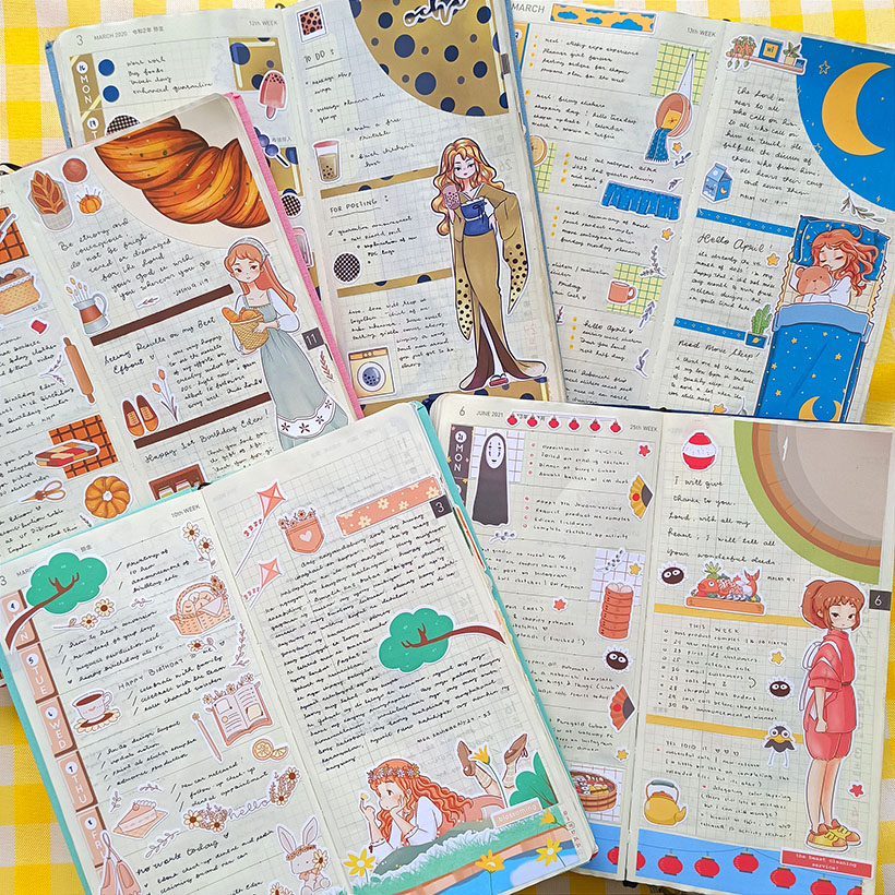 Collection of colorful illustrated notebooks and pages with drawings of girls, animals, and objects, arranged in a flat layout.